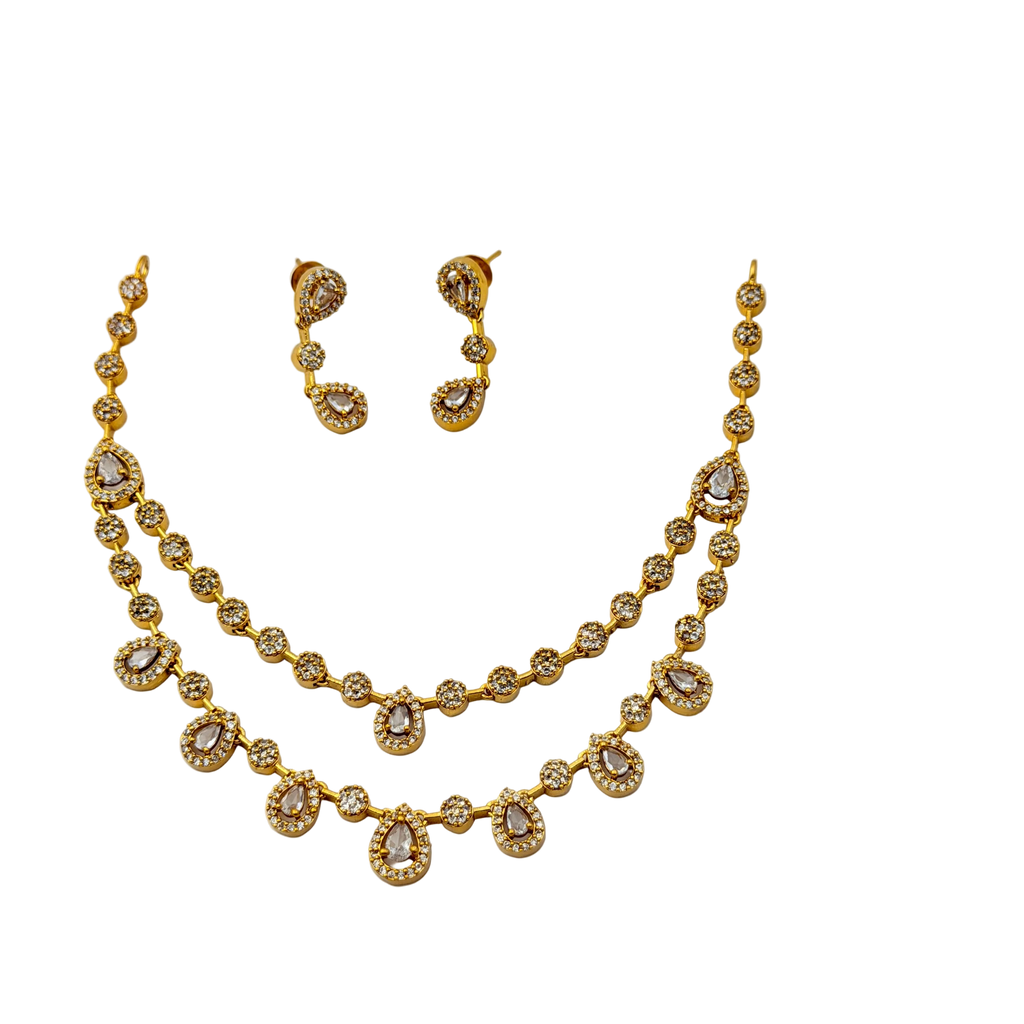 Gold necklace and earrings set on a white background