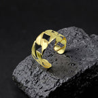 Gold bracelet on a textured black surface