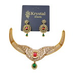 Gold necklace with red and green gemstones and matching earrings on a Krystal Jewels card.