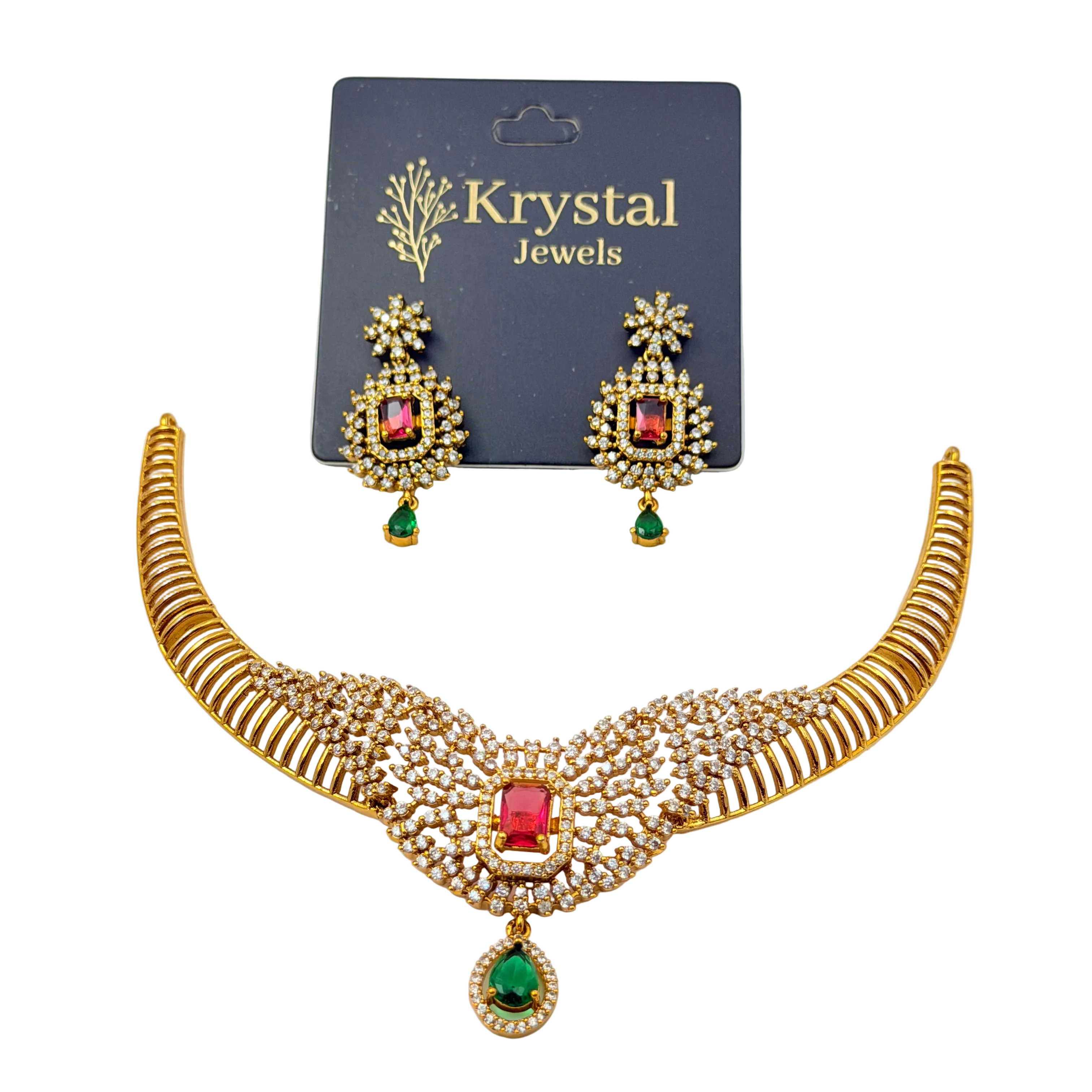 Gold necklace with red and green gemstones and matching earrings on a Krystal Jewels card.