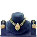 Gold and green jewelry set on a blue velvet stand with a white background