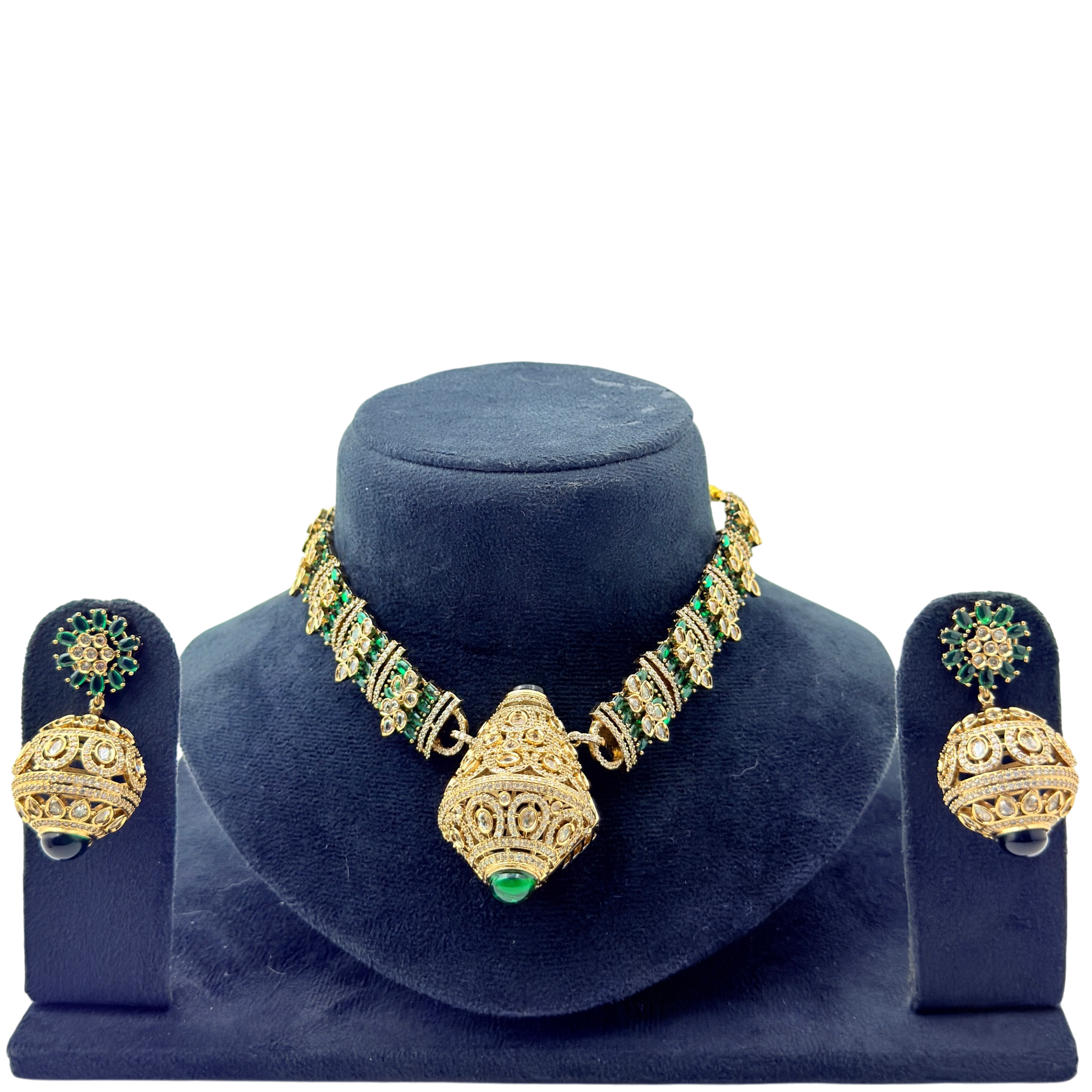 Gold and green jewelry set on a blue velvet stand with a white background