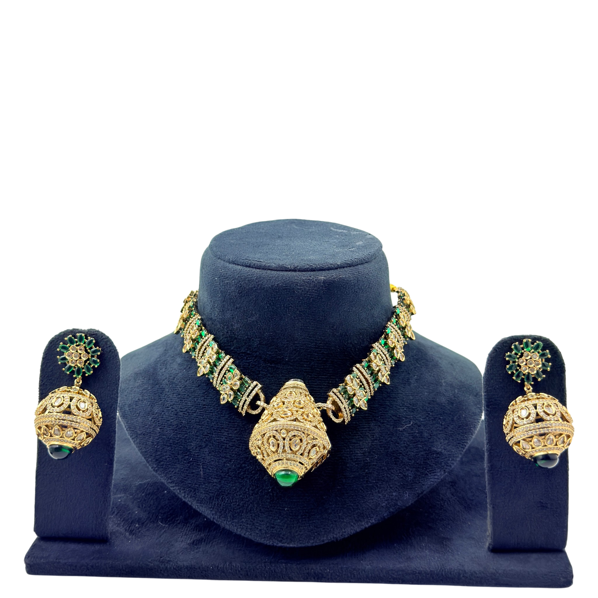 Gold and green jewelry set on a blue velvet stand with a white background