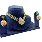 Gold and green jewelry set on a blue velvet stand