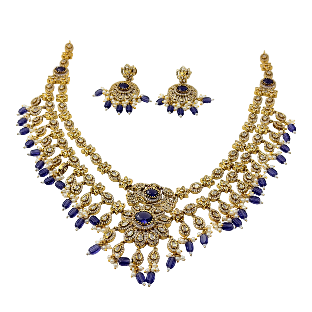 Gold and blue necklace set on a white background