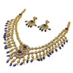 Gold and blue jewelry set on a white background