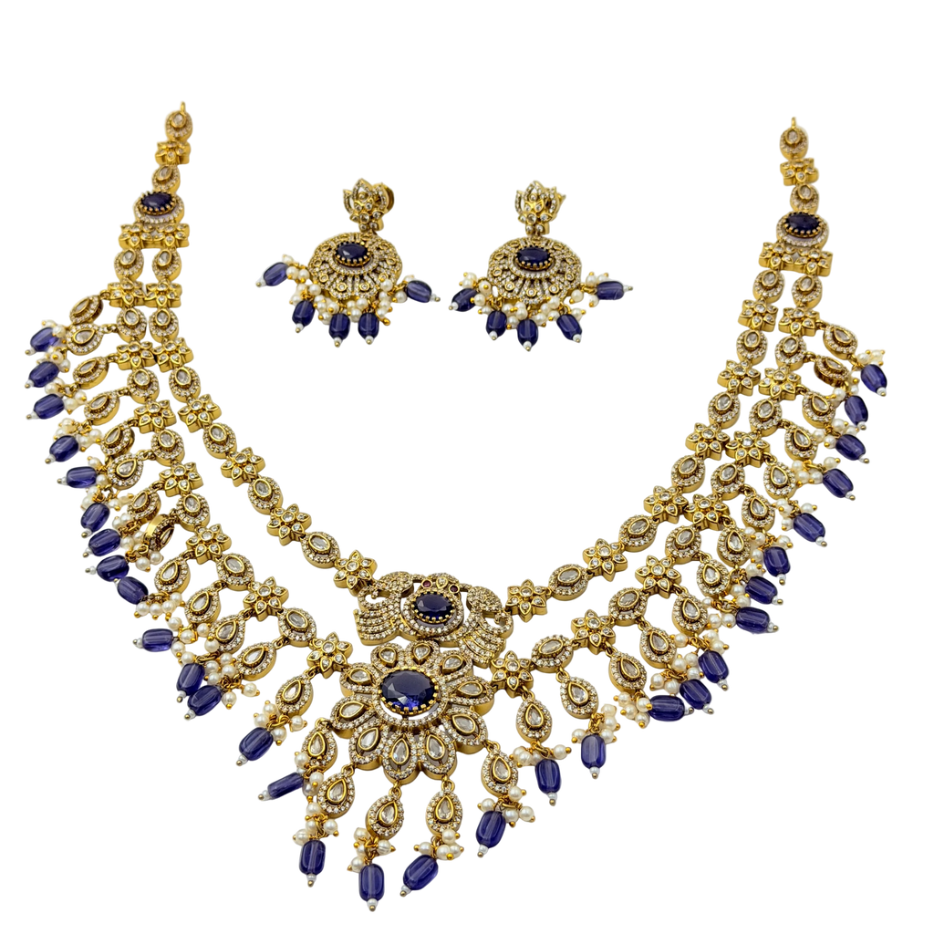 Gold and blue necklace set on a white background