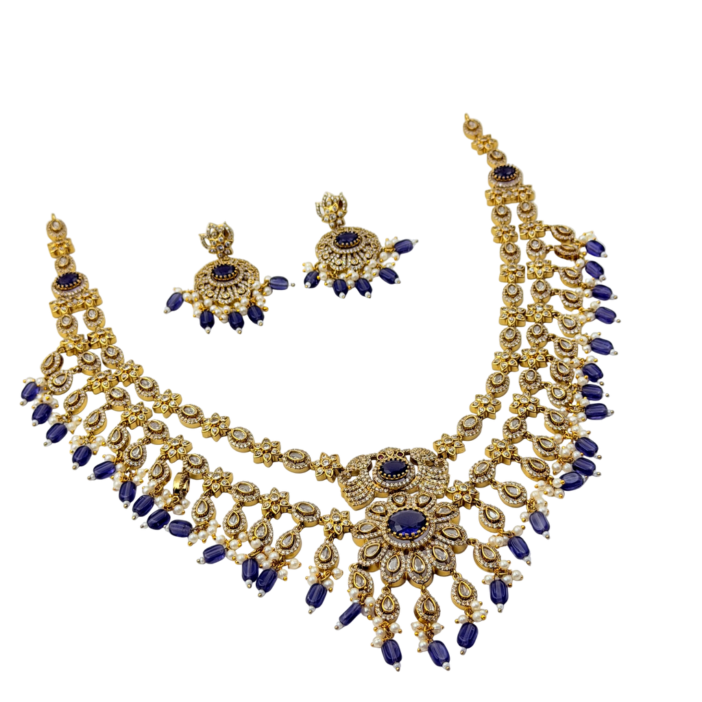 Gold and blue necklace set on a white background