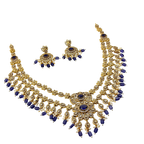 Gold and blue necklace set on a white background