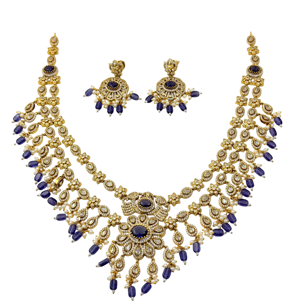 Gold and blue necklace set on a white background