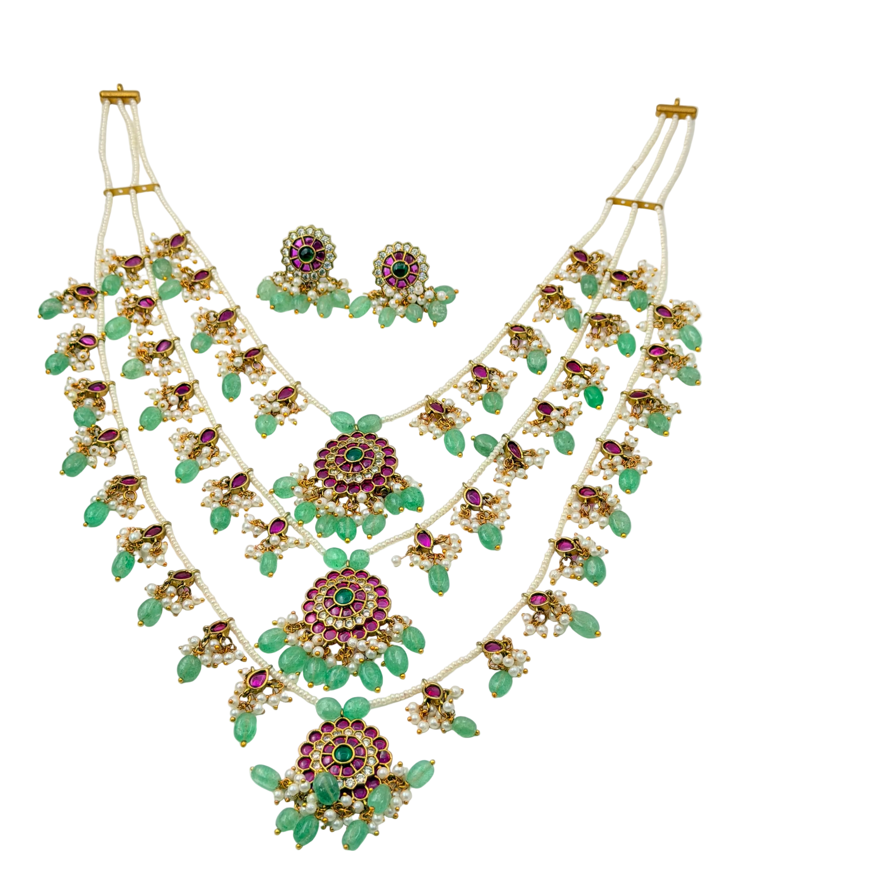 Ornate necklace with green and red gemstones on a white background