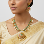 Woman wearing a traditional gold necklace and earrings with a beige saree.