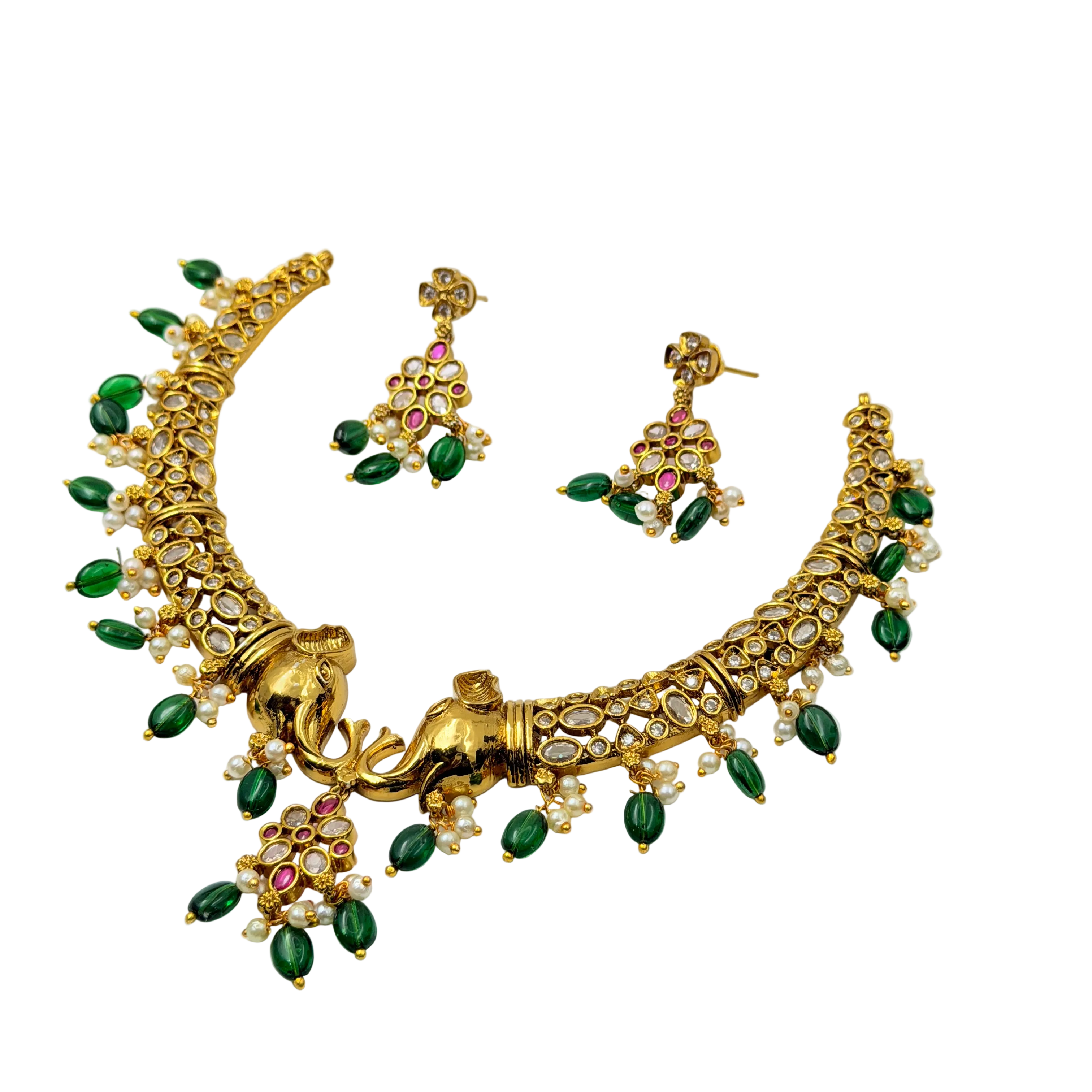 Gold necklace with green and red stones on a white background