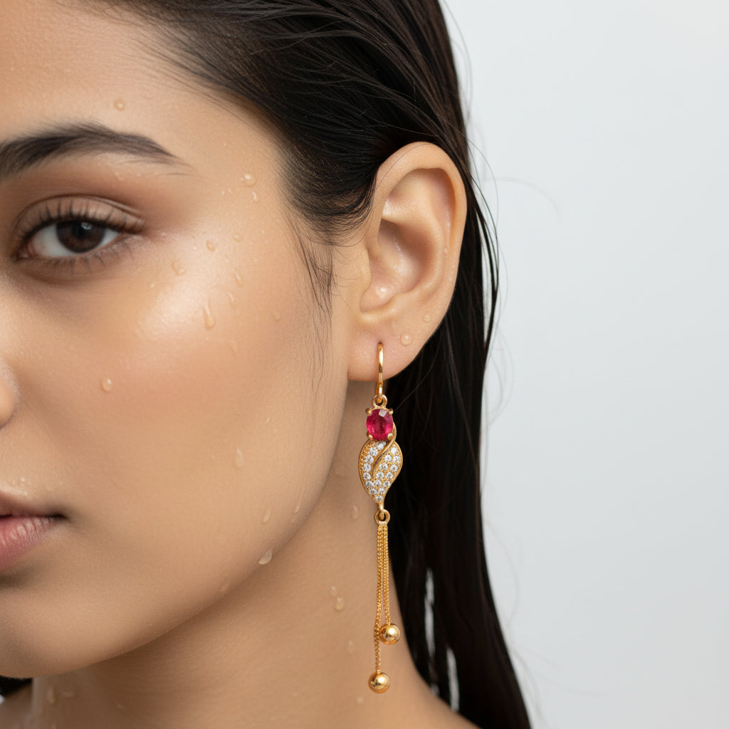 Gold earrings with red gemstones