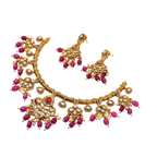 Gold necklace with pink stones on a white background