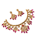 Gold necklace with pink gemstones on a white background