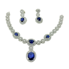 Jewelry set with necklace and earrings featuring blue gemstones on a white background