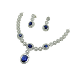 Jewelry set with necklace and earrings featuring blue gemstones on a white background