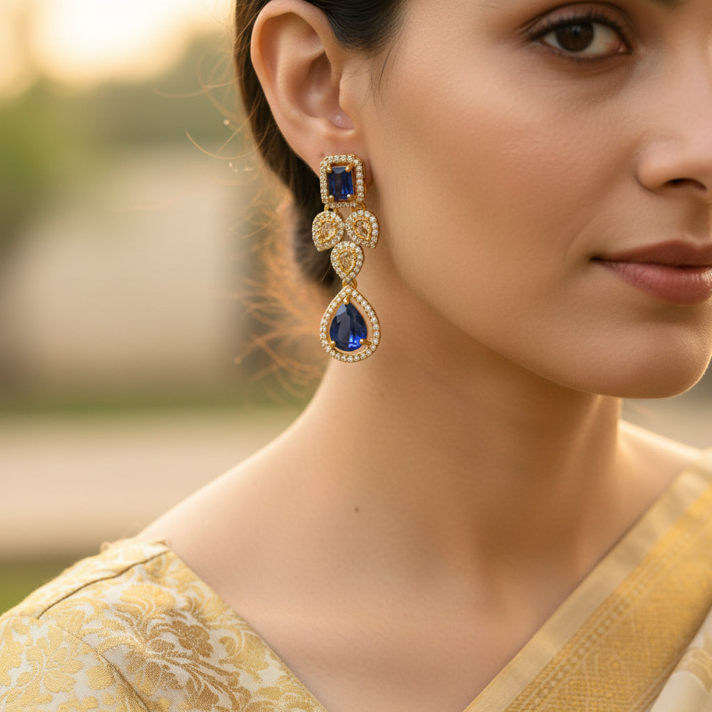 Pair of earrings with blue gem