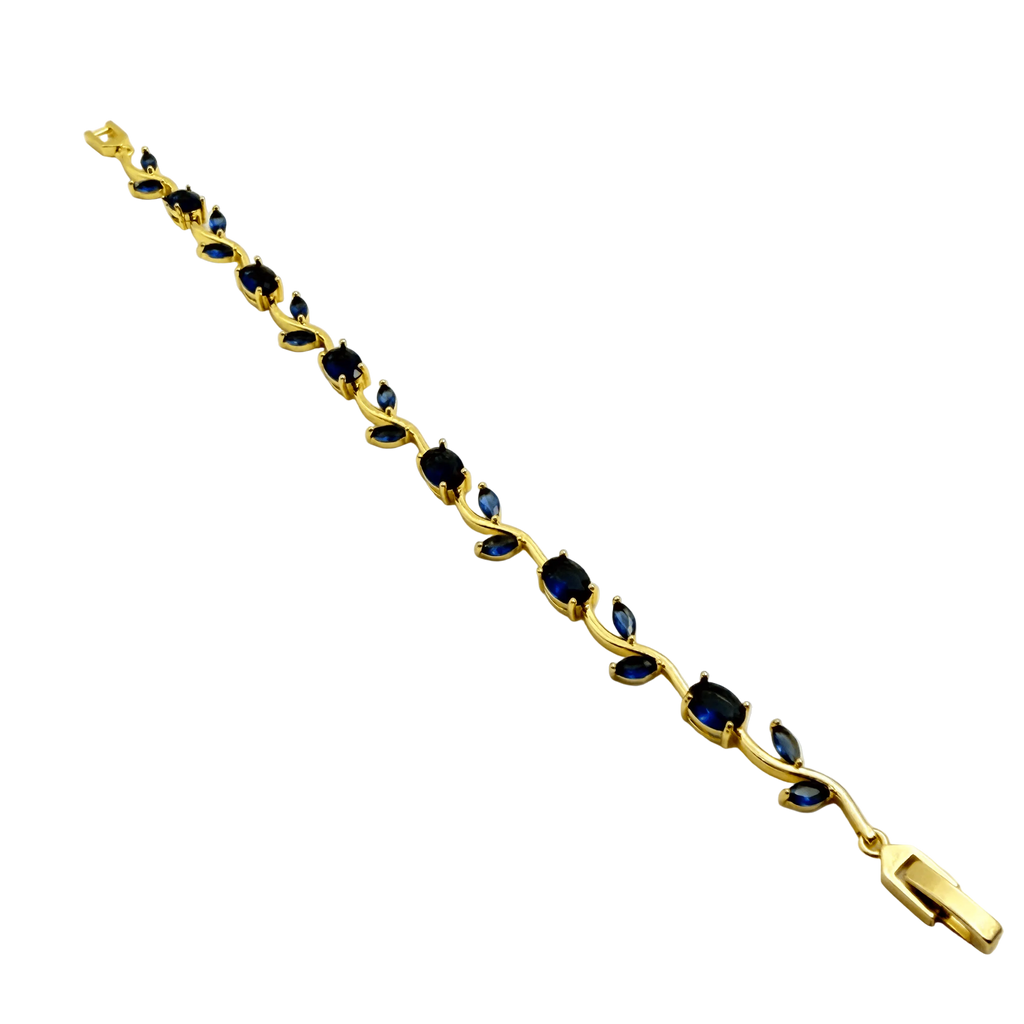 Gold bracelet with blue stones on a white background