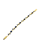 Gold bracelet with blue stones on a white background