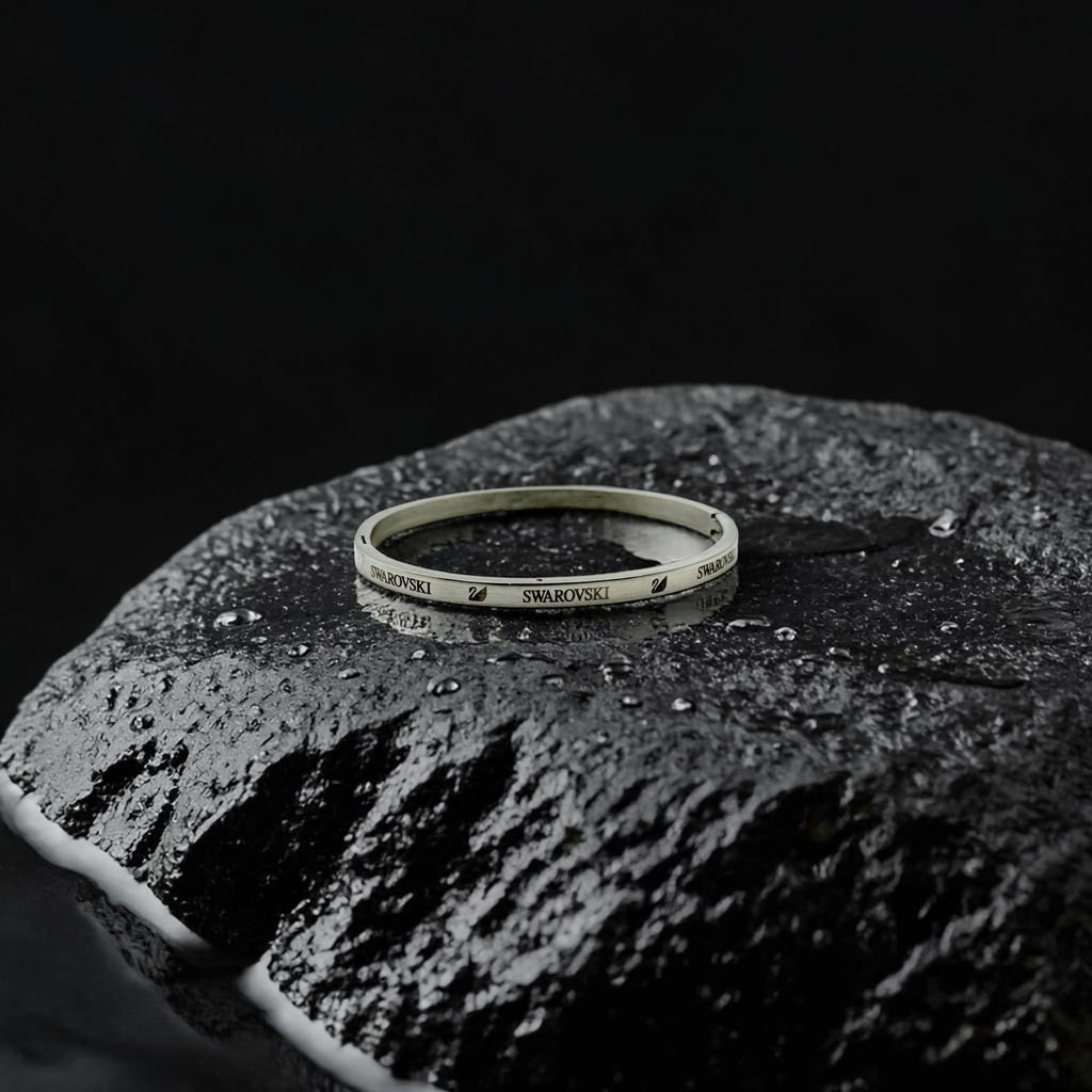 Swarovski bracelet on a textured black surface with a dark background