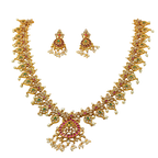 Gold necklace and earrings set with gemstones on a white background