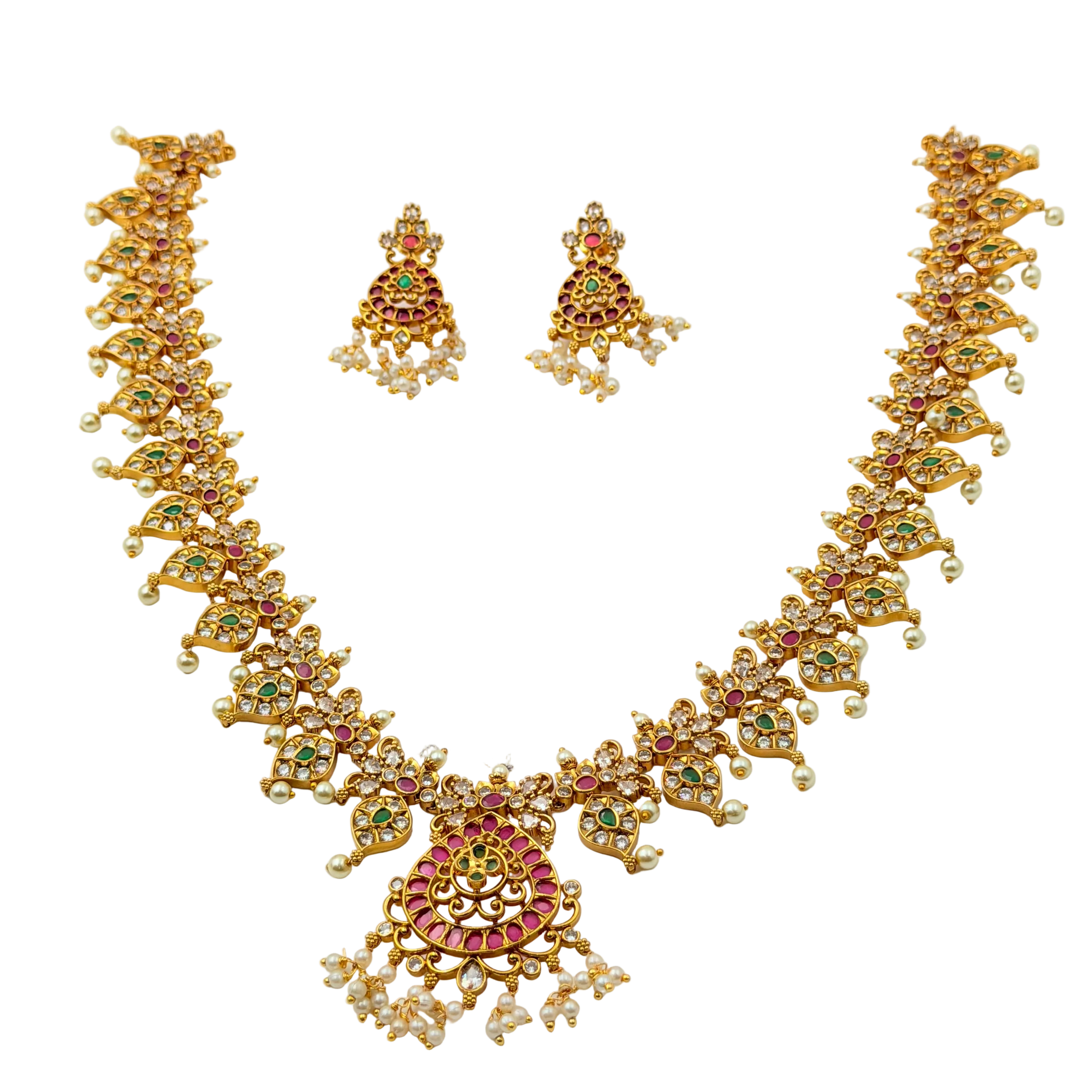 Gold necklace and earrings set with gemstones on a white background