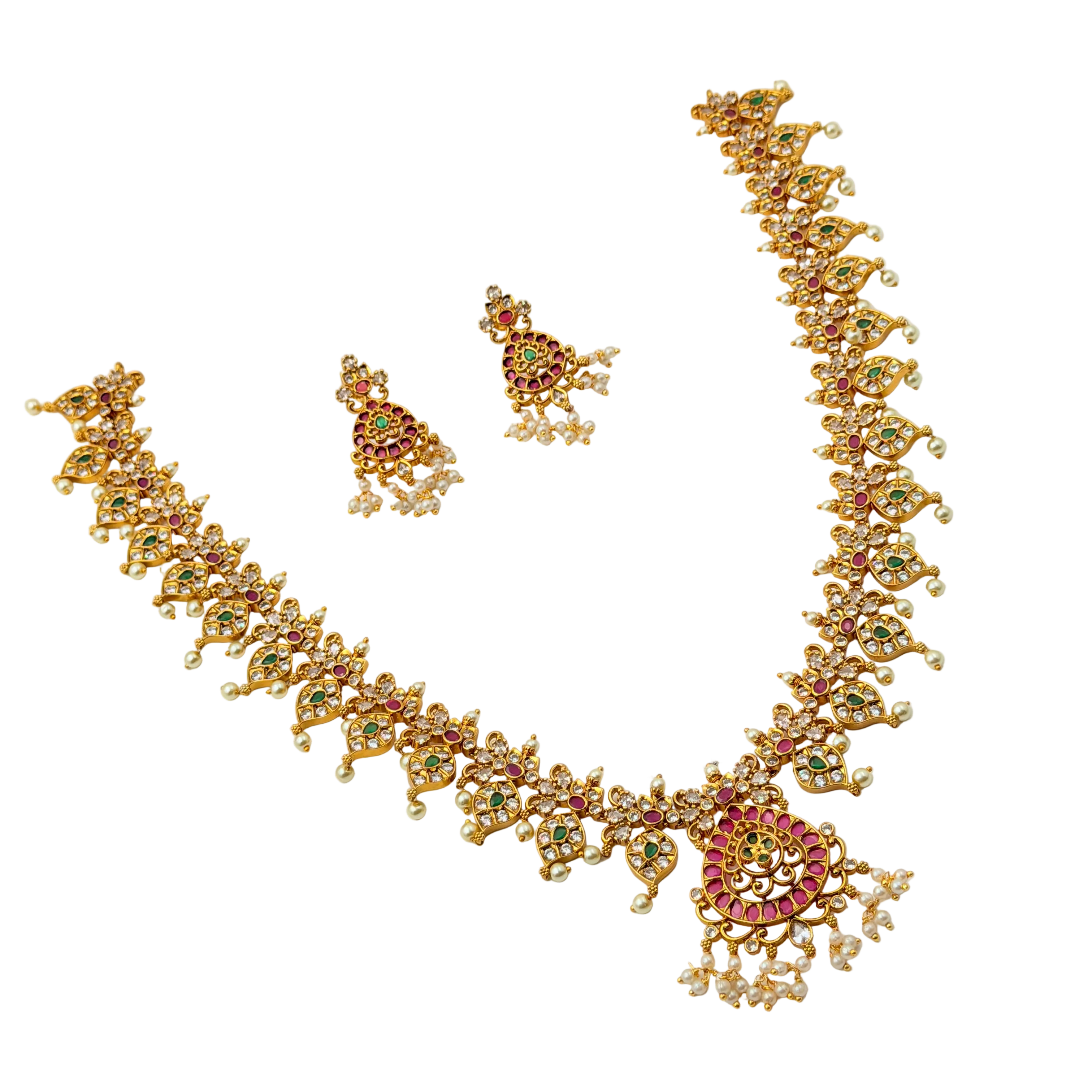 Gold necklace and earrings set with gemstones on a white background