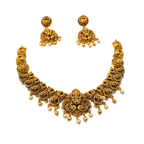 Gold necklace and earrings set on a white background