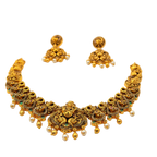 Gold necklace and earrings set on a white background