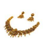 Gold necklace and earrings set on a white background