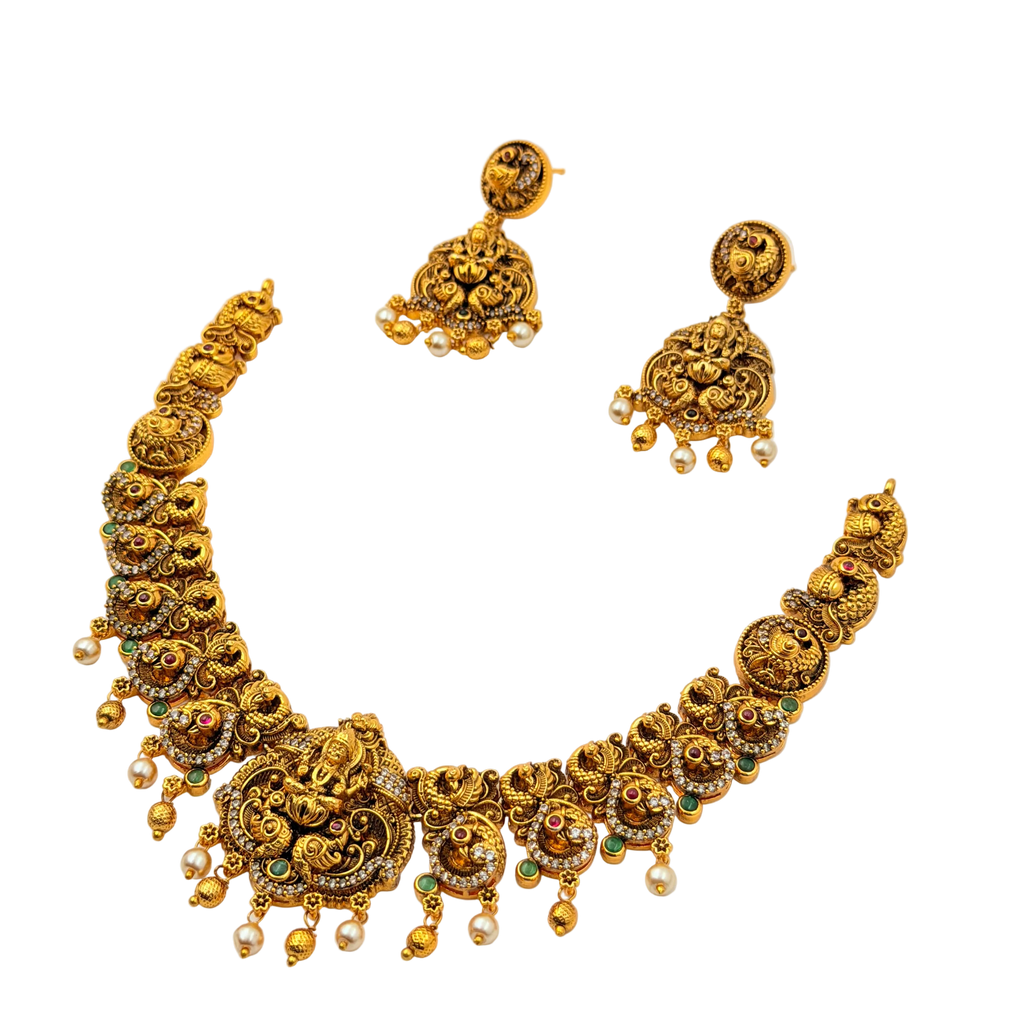 Gold necklace and earrings set on a white background