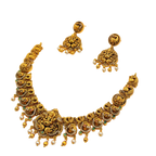 Gold necklace and earrings set on a white background