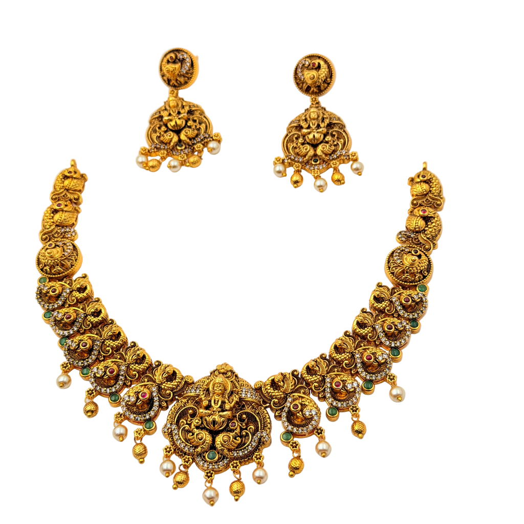 Gold necklace and earrings set on a white background