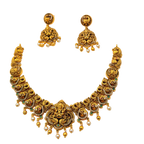 Gold necklace and earrings set on a white background