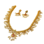 Gold necklace with pearl accents and gemstones on a white background