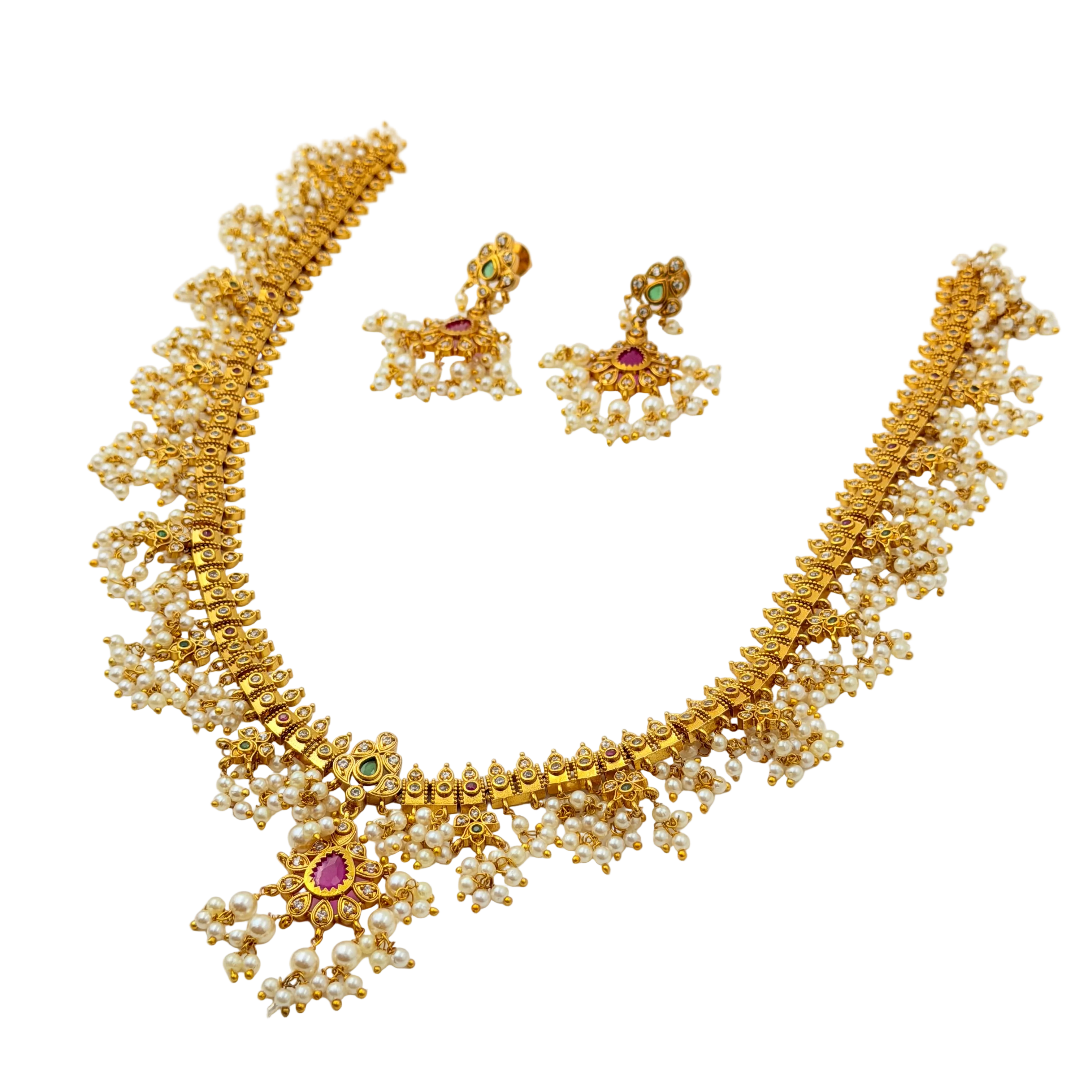 Gold necklace with pearl accents and gemstones on a white background