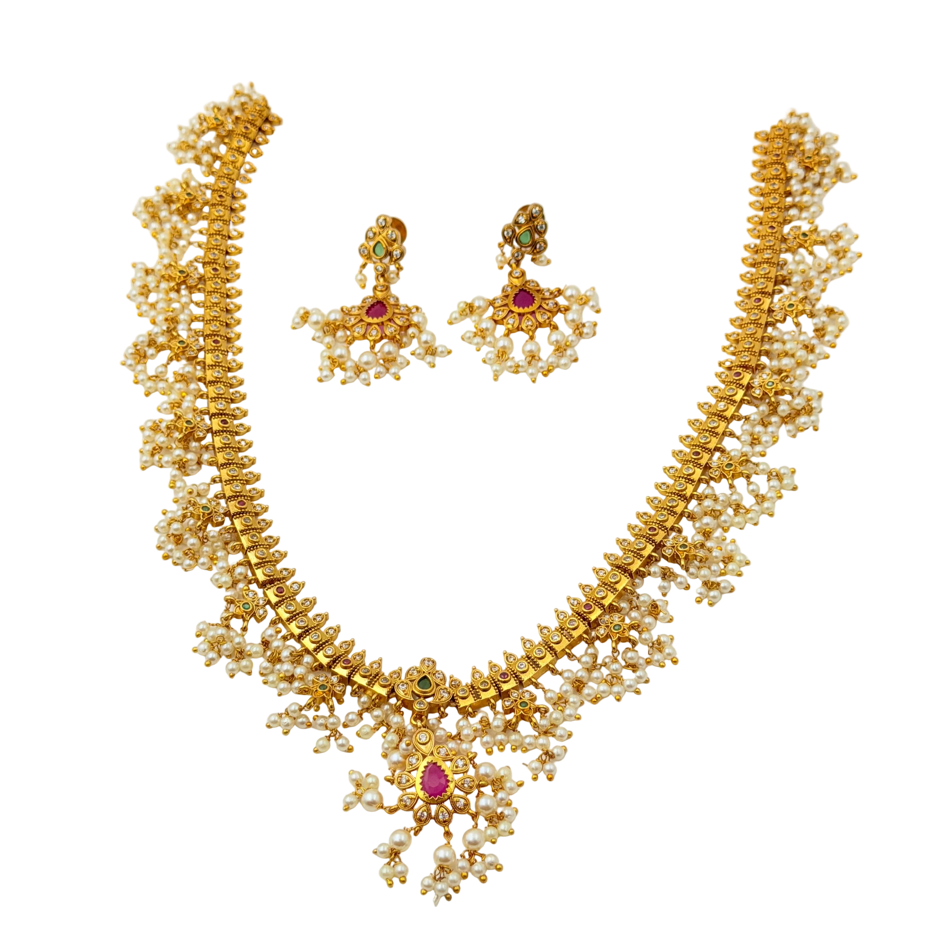 Gold necklace and earrings with gemstones on a white background
