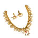Gold necklace with pearls and gemstones on a white background