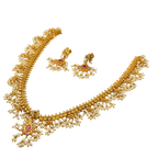 Gold necklace with pearls and gemstones on a white background