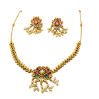 Gold necklace and earrings set with gemstones on a white background
