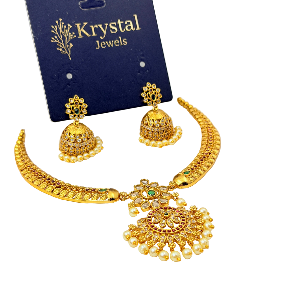 Gold jewelry set with necklace and earrings on a Krystal Jewels card.