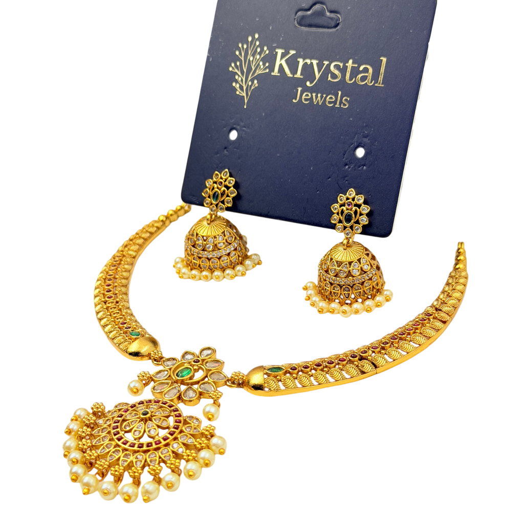 Gold necklace and earrings set on a Krystal Jewels card