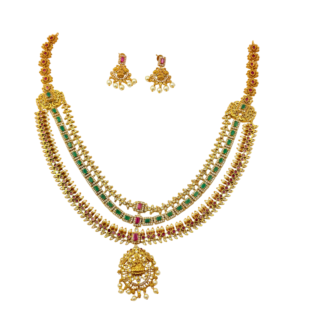 Gold necklace with emeralds and rubies on a white background