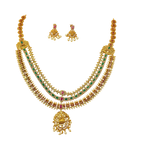 Gold necklace with emeralds and rubies on a white background