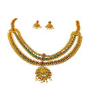 Gold necklace with green and red stones on a white background