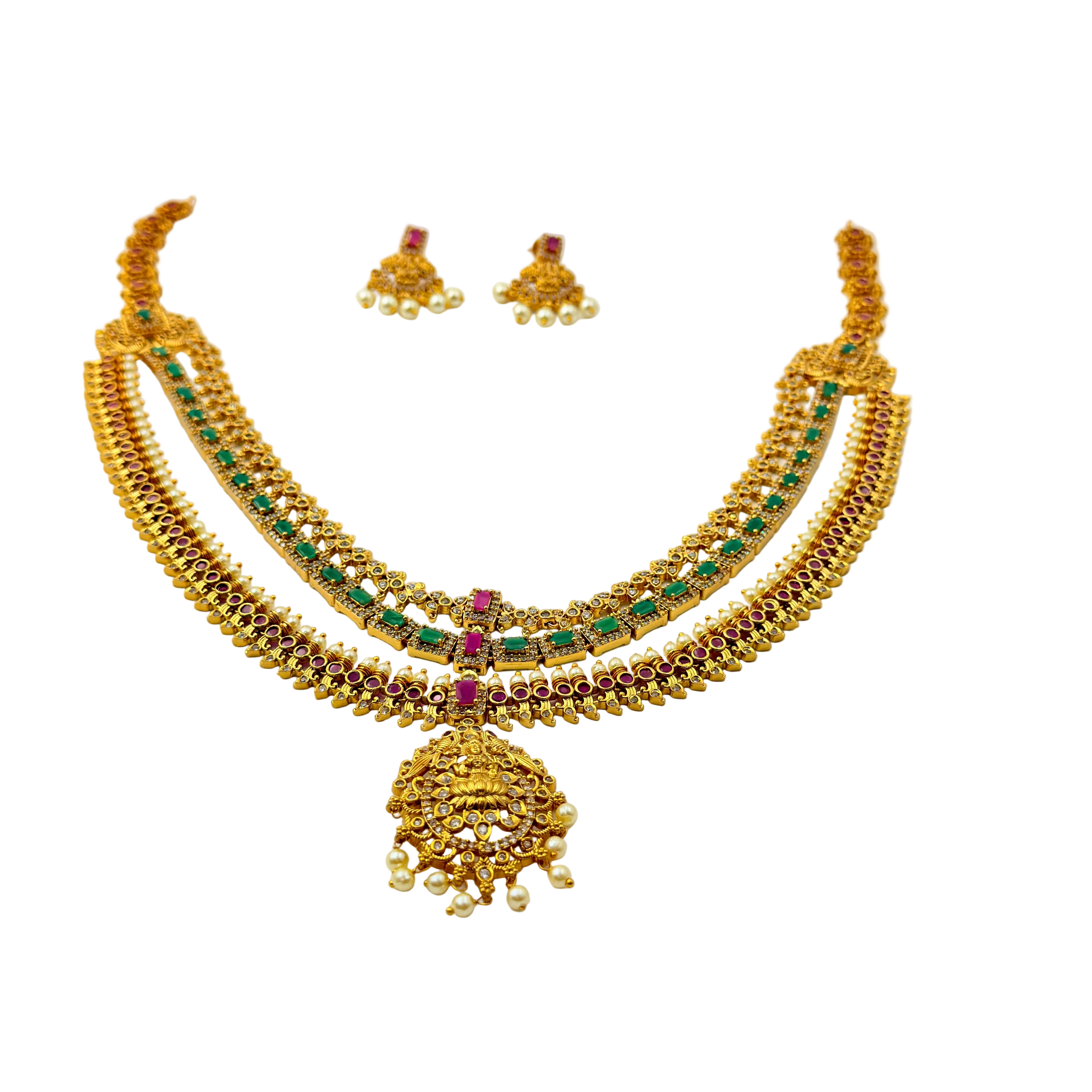 Gold necklace with green and red stones on a white background