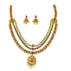 Gold necklace with green and red stones on a white background