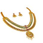 Gold necklace with green and red stones on a white background